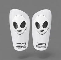A pair of TREDCAL brand soccer shin guards with patented 3D alien logo.