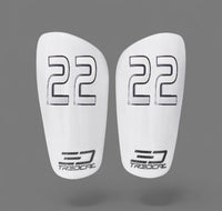 A pair of TREDCAL brand soccer shin guards with patented 3D number in pirulen font.