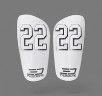 A pair of TREDCAL brand soccer shin guards with patented 3D number in varsity font.