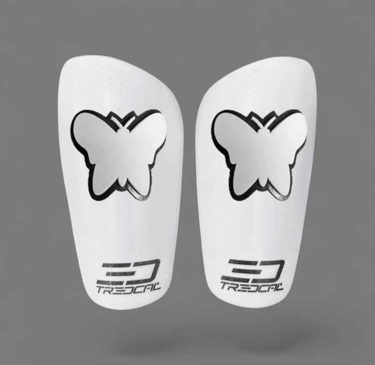 A pair of TREDCAL brand soccer shin guards with patented 3D butterfly logo.