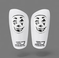 A pair of TREDCAL brand soccer shin guards with patented 3D clown face logo.