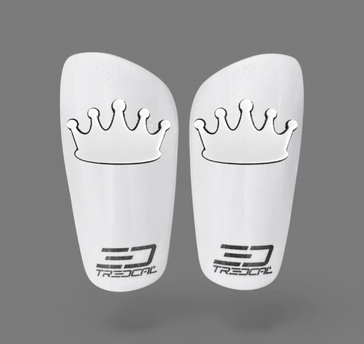 Pair of white shin guards with crown design and Tredcal branding