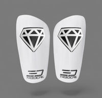 A pair of TREDCAL brand soccer shin guards with patented 3D diamond logo.