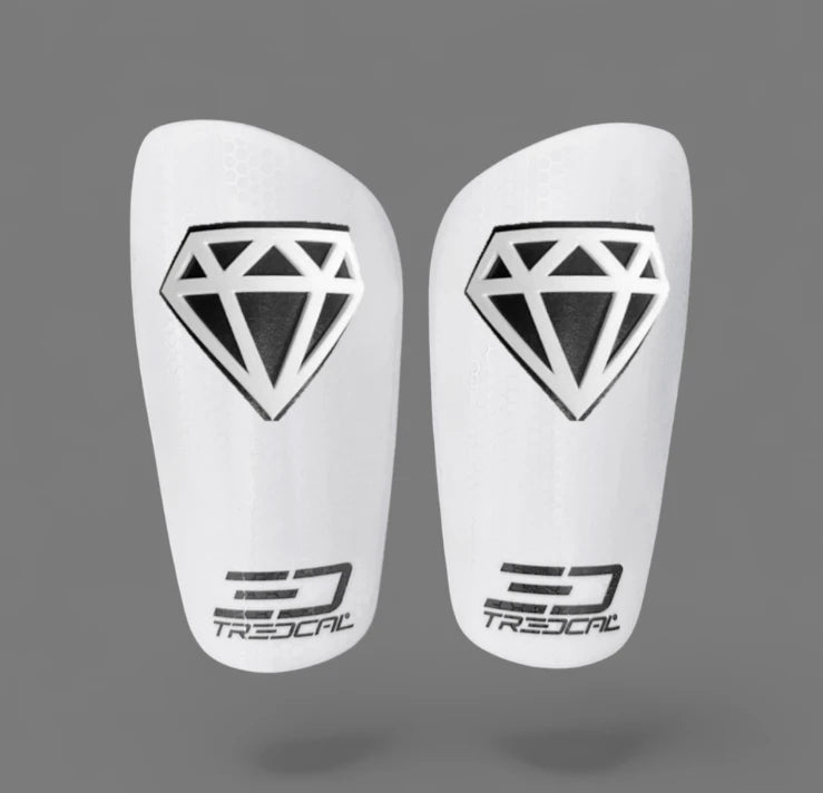 A pair of TREDCAL brand soccer shin guards with patented 3D diamond logo.
