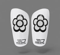 Pair of white shin guards with black flower designs and Tredcal branding 