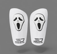 White shin guards with black 'scream' face design and Tredcal logo