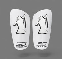A pair of TREDCAL brand soccer shin guards with patented 3D grim reaper logo.