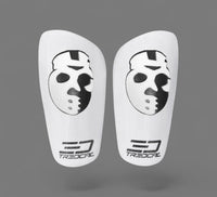 A pair of TREDCAL brand soccer shin guards with patented 3D hockey mask logo.
