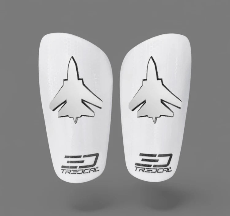 A pair of TREDCAL brand soccer shin guards with patented 3D jet logo.