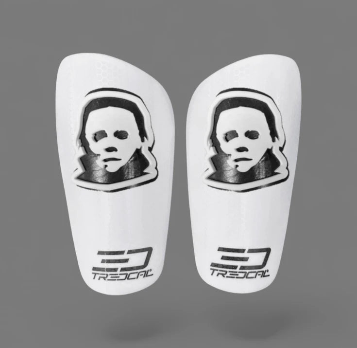A pair of TREDCAL brand soccer shin guards with patented 3D Mask logo.