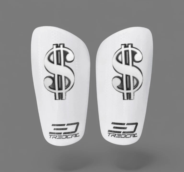A pair of TREDCAL brand soccer shin guards with patented 3D money/dollar sign logo.