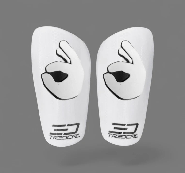A pair of TREDCAL brand soccer shin guards with patented 3D OK logo.