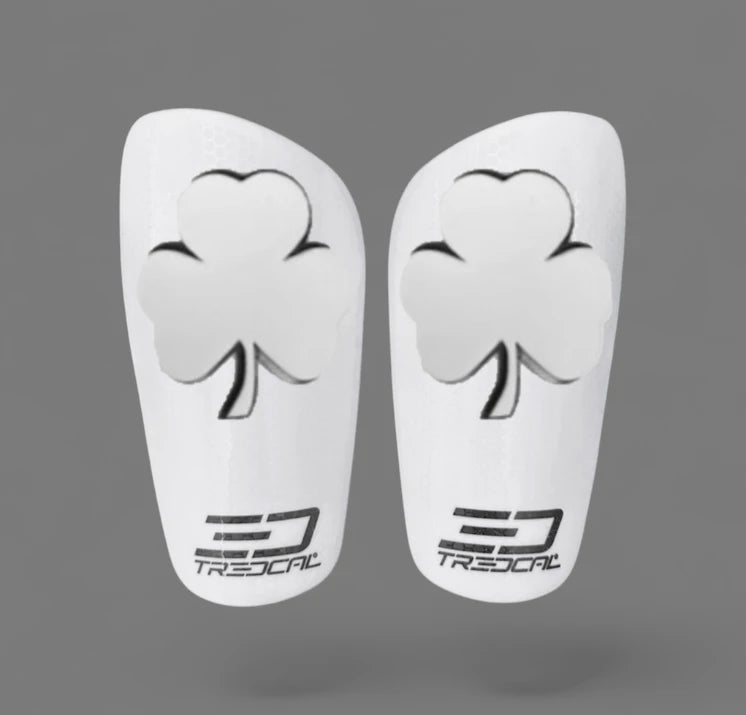 A pair of TREDCAL brand soccer shin guards with patented 3D shamrock logo.