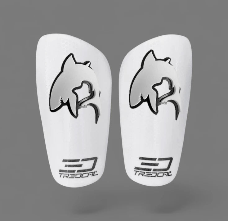 A pair of TREDCAL brand soccer shin guards with patented 3D shark logo.