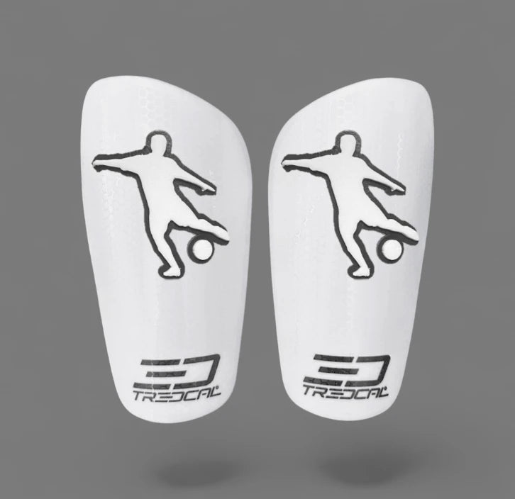 A pair of TREDCAL brand soccer shin guards with patented 3D soccer player logo.