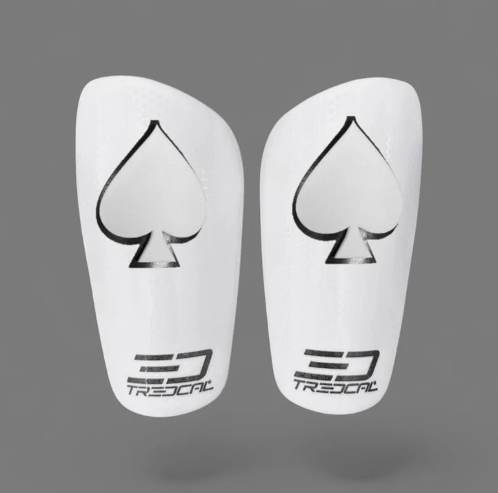 A pair of TREDCAL brand soccer shin guards with patented 3D spades logo.