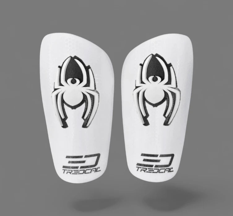 A pair of TREDCAL brand soccer shin guards with patented 3D spider logo.