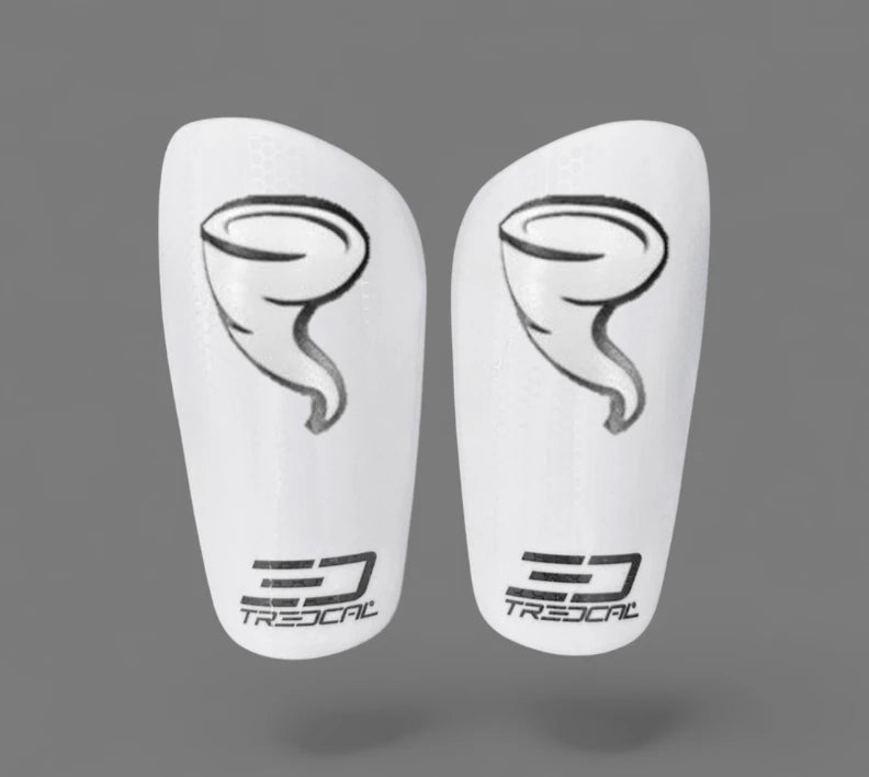 A pair of TREDCAL brand soccer shin guards with patented 3D storm/tornado logo.