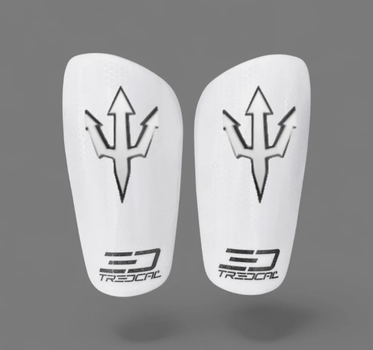 A pair of TREDCAL brand soccer shin guards with patented 3D trident/pitch fork logo.